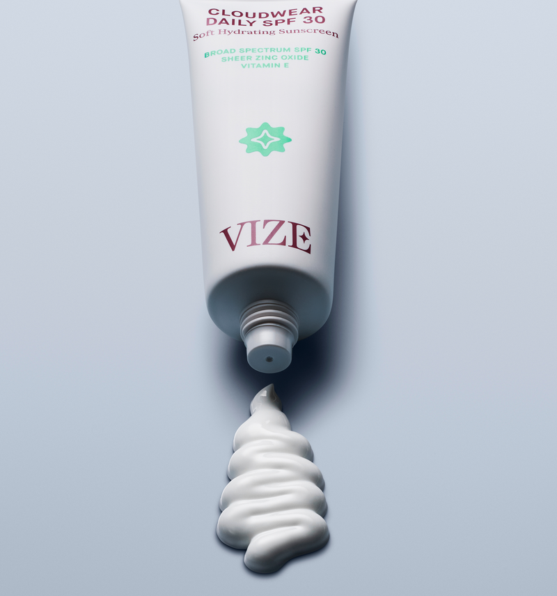 tube of cloudwear daily spf 30 laying on a blue background with a squiggle of product squeezed out of the tube